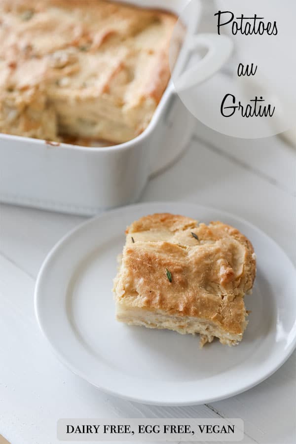 A Pinterest pin ofr vegan potatoes au gratin with a picture of a square of the potatoes on a white plate and the pan of potatoes in the background.