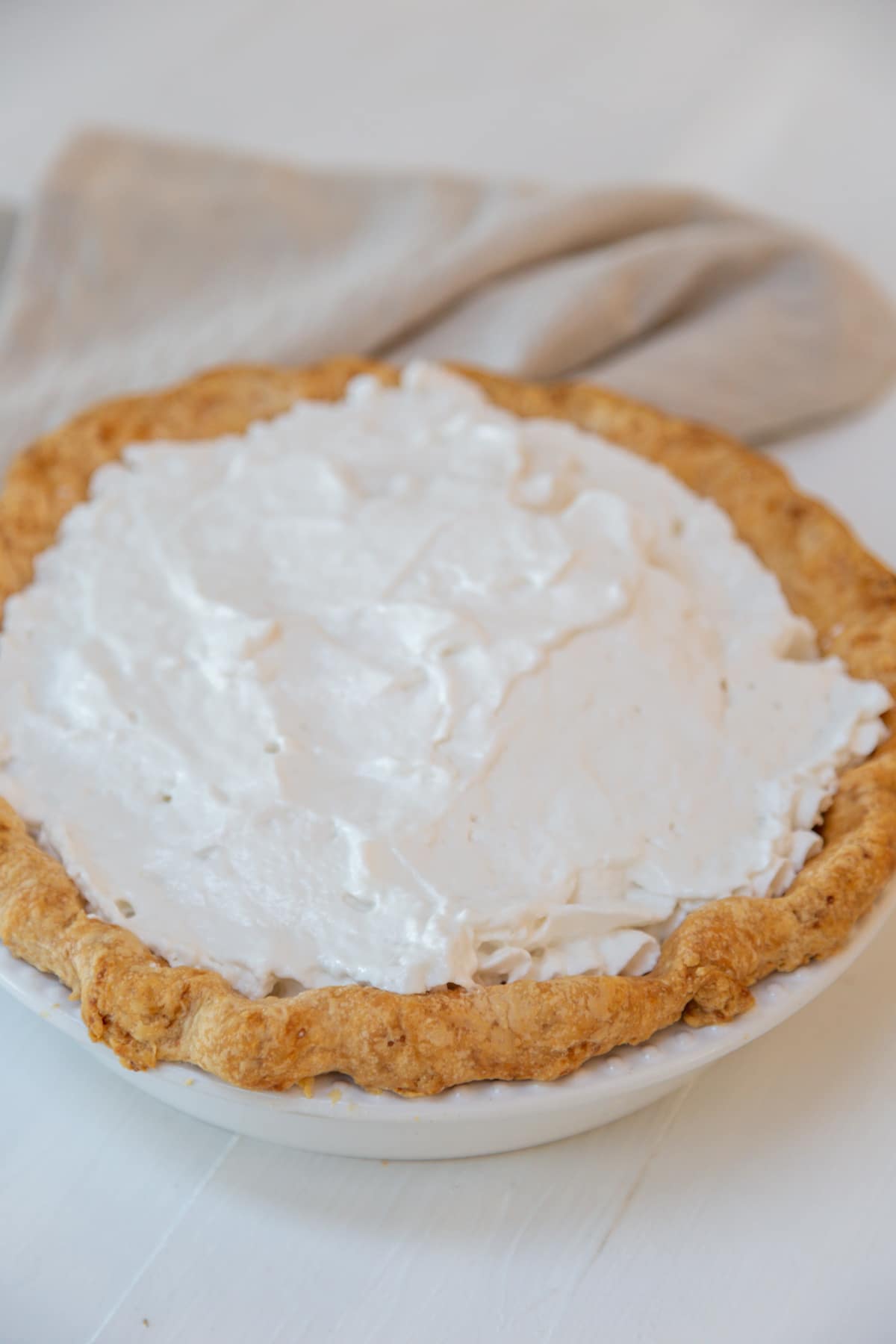 A pie with whipped cream topping.