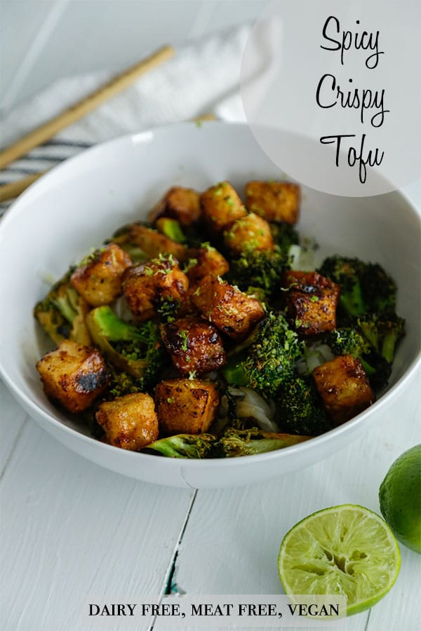 A Pinterest pin for spicy crispy tofu bites with a picture of a white bowl filled with the tofu bites, broccoli, and rice.