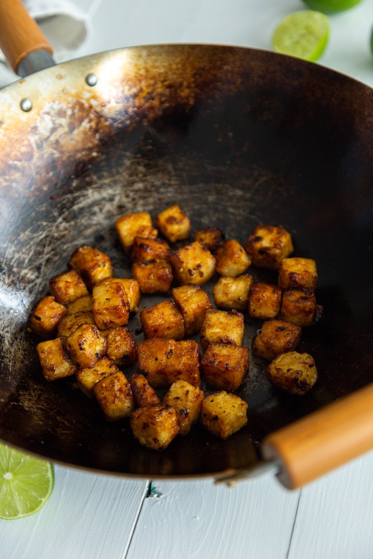 Crispy tofu cubes in a wok.