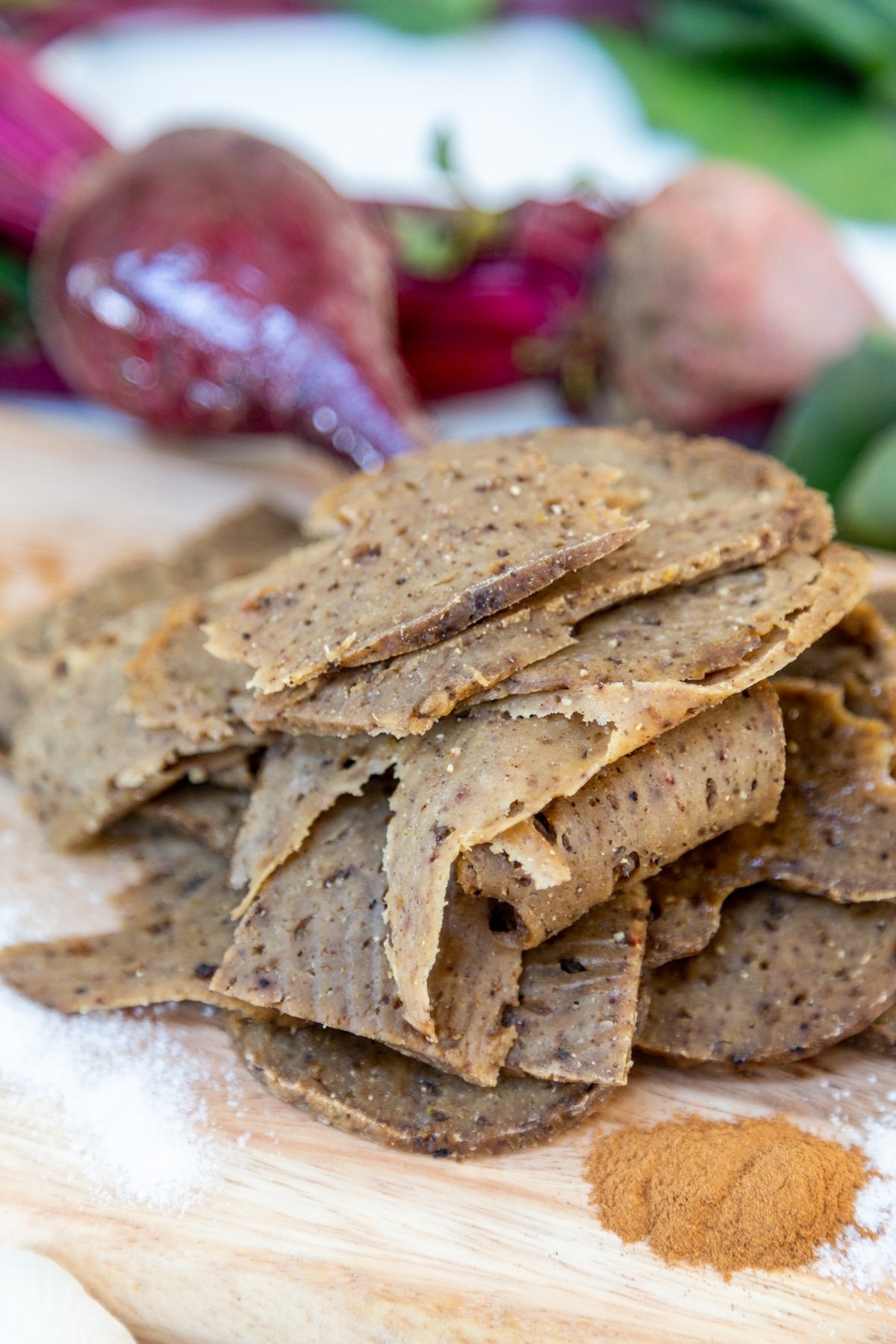 Sliced roast on a wooden board with spices.