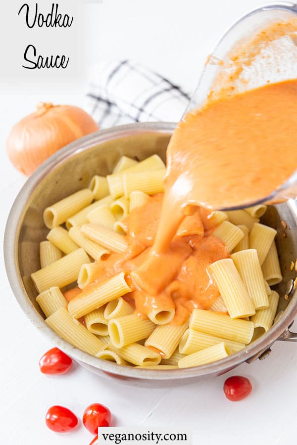 A Pinterest pin for vegan vodka sauce with a picture of the sauce being poured over pasta.