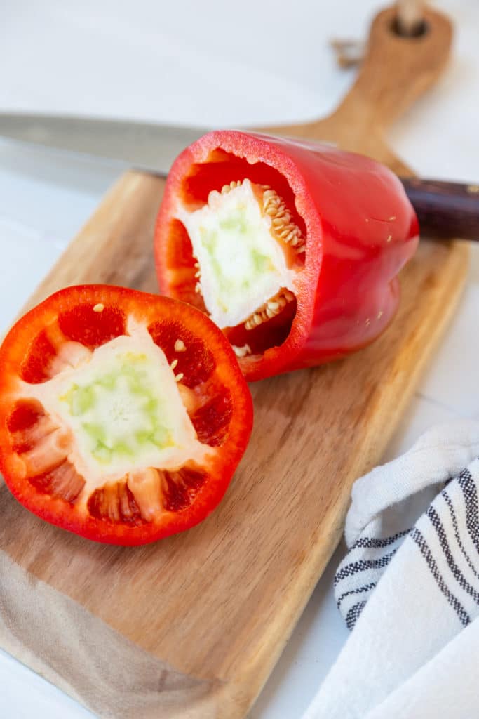 A red bell pepper with the top cut off.
