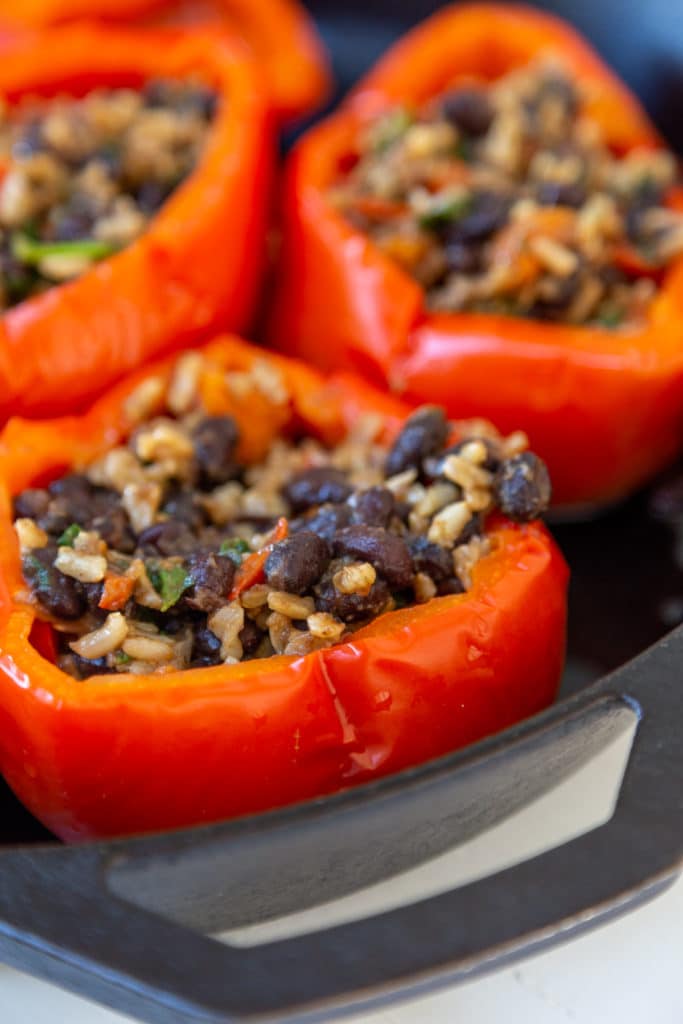 red bell peppers stuffed with beans and rice.