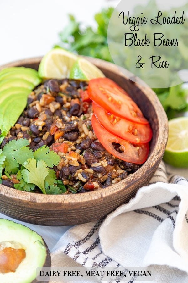 A PInterest pin for black beans and rice with a picture of the recipe in a brown wood bowl.