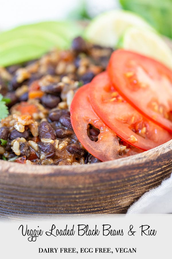A PInterest pin for veggie loaded black beans and rice with a picture of the recipe in a wooden bowl.