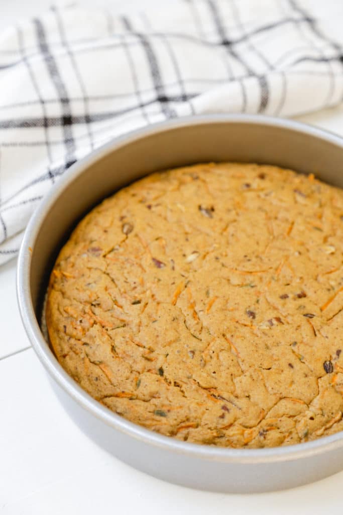Baked carrot cake in a round cake pan.