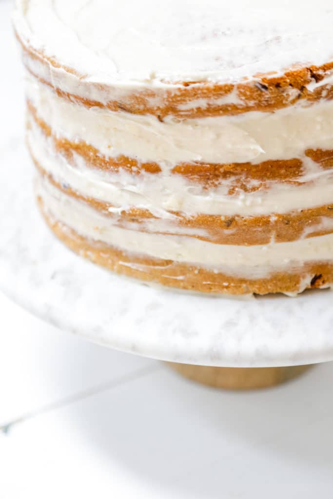 A 4 tiered carrot cake with cream cheese frosting.