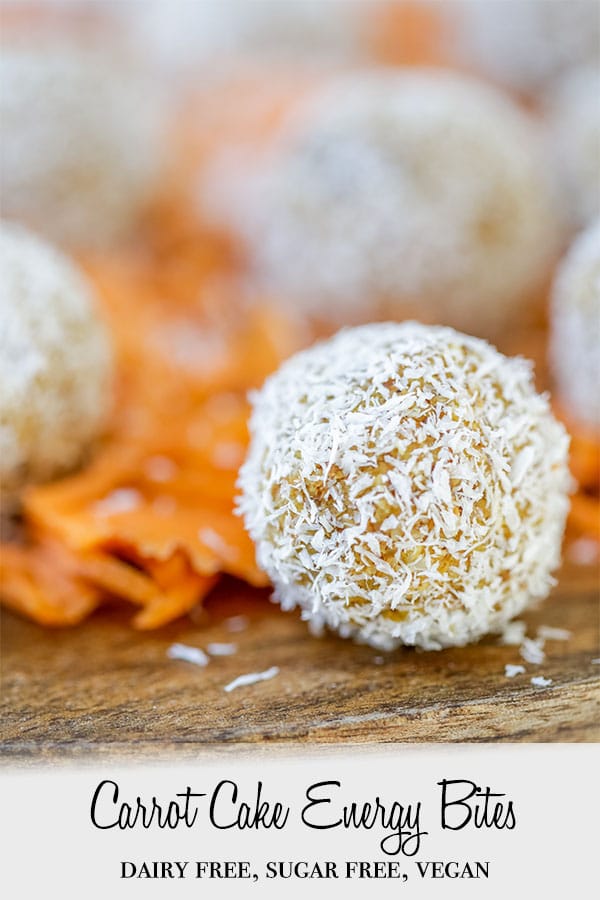 A PInterest pin for carrot cake energy bites with a picture of the bite rolled in shredded coconut sitting on shredded carrots.