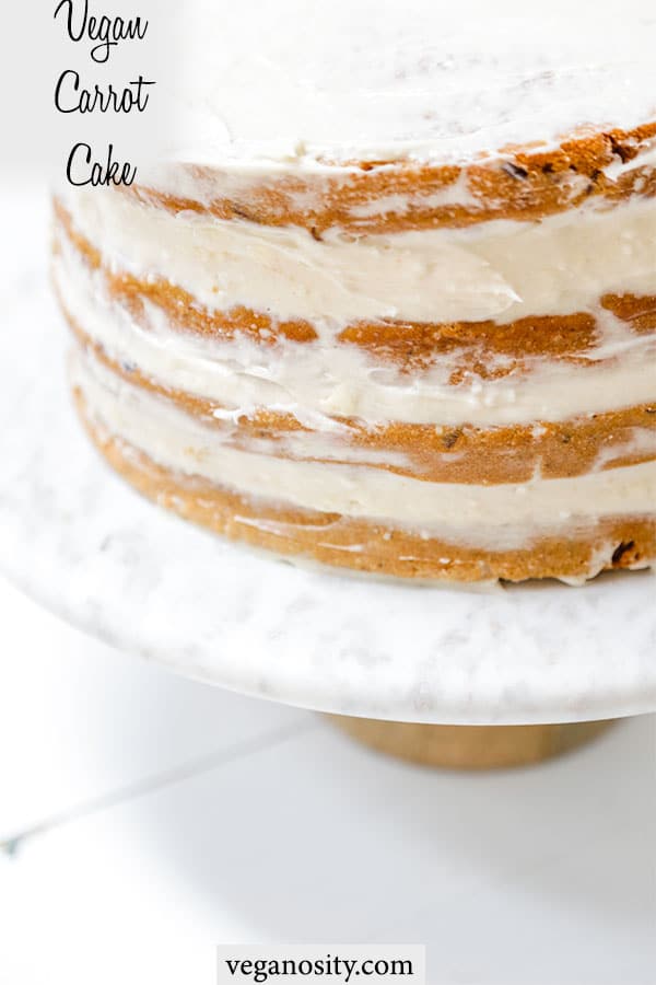 A Pinterest pin for vegan carrot cake with a picture of a 4 tiered frosted cake.
