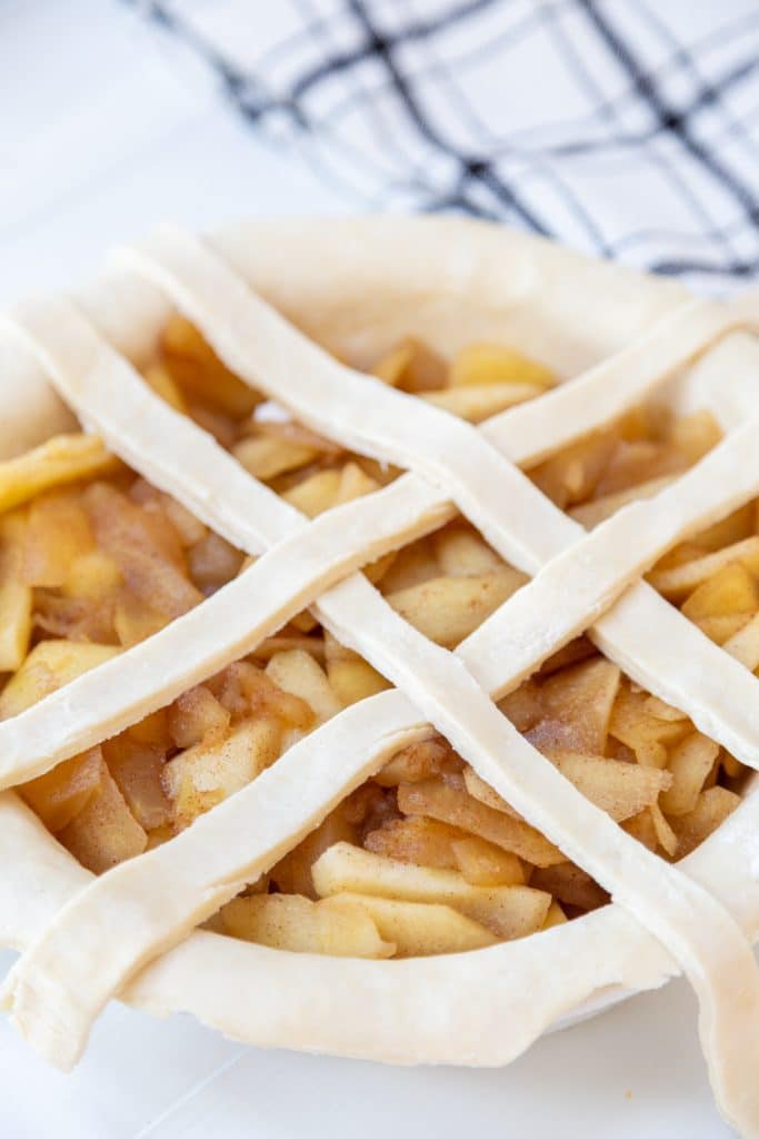 An apple pie with the beginnings of a lattice top.