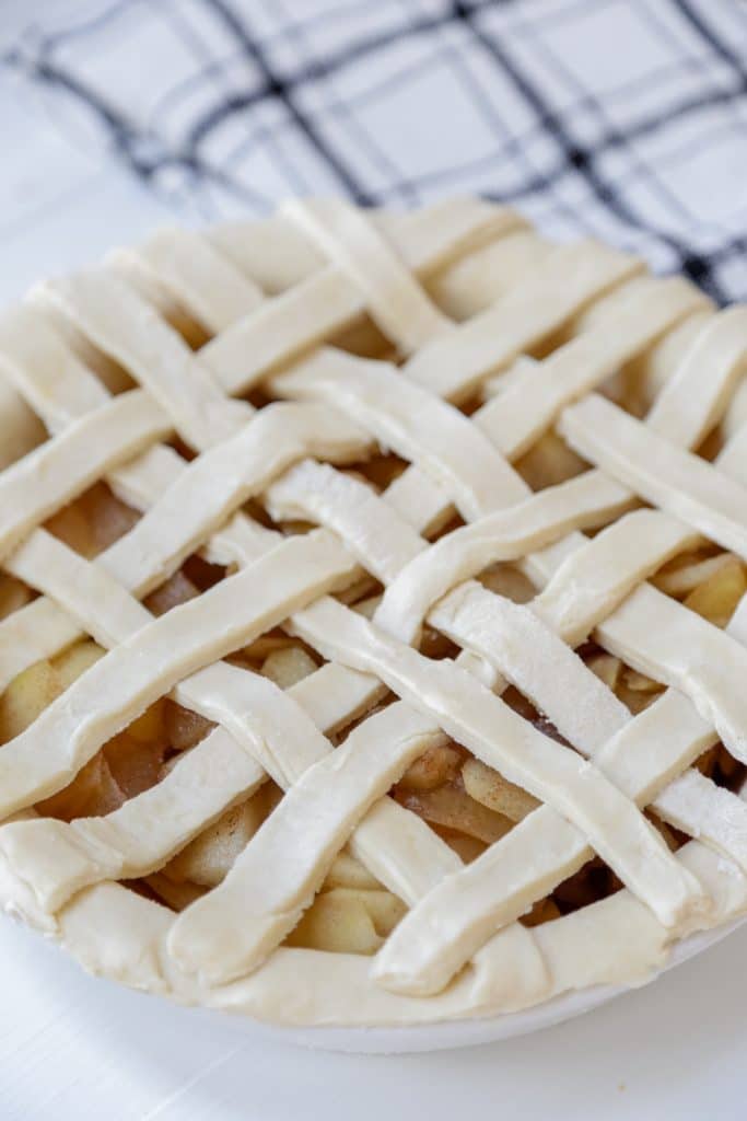 An unbaked apple pie with a lattice top.