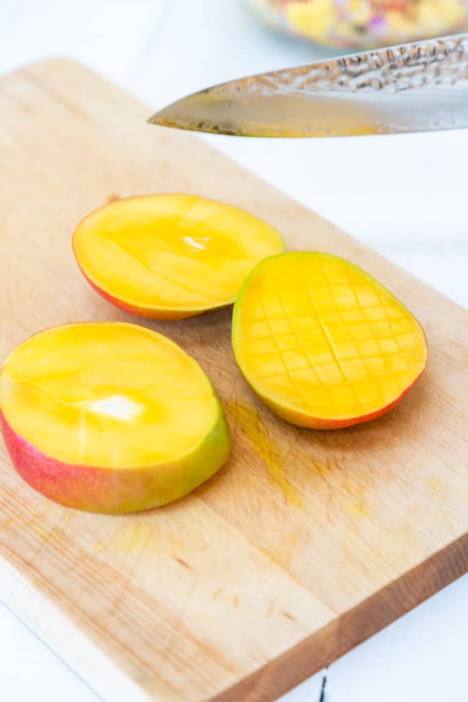 Sliced mango on a wooden board. 