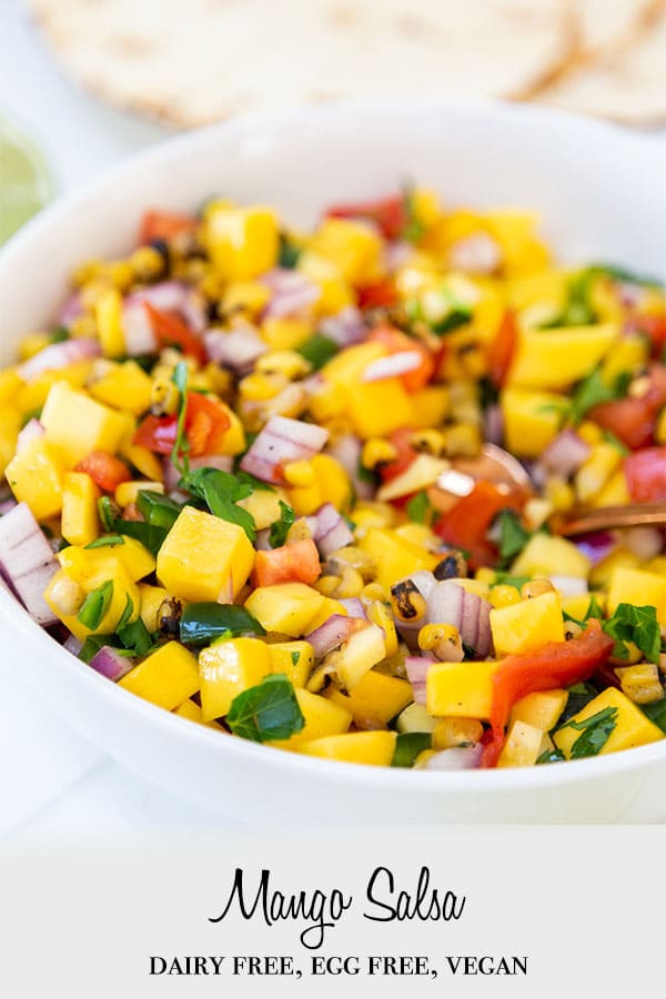 A Pinterest pin for mango salsa with a picture of the salsa in a white bowl.
