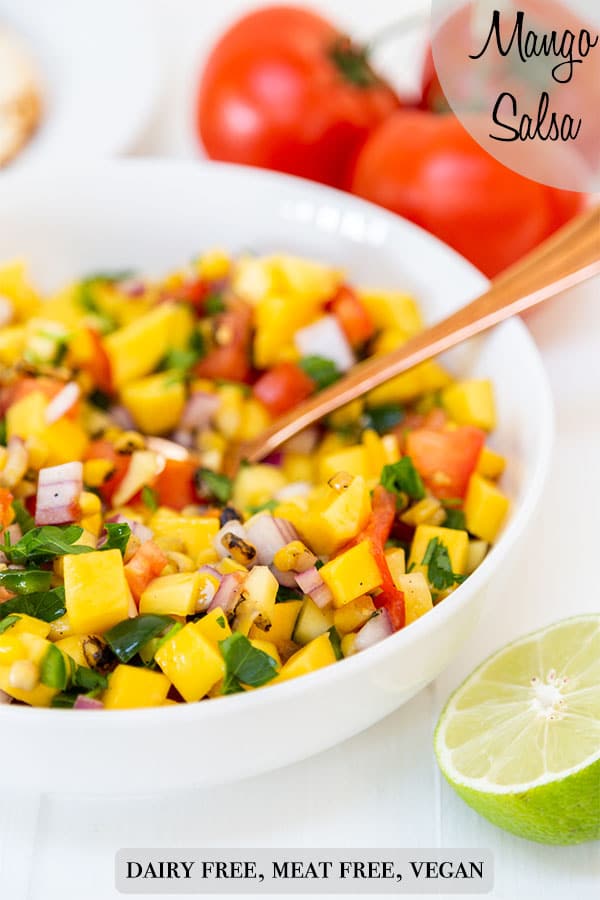A PInterest pin for mango salsa with a picture of the salsa in a white bowl with a gold spoon.