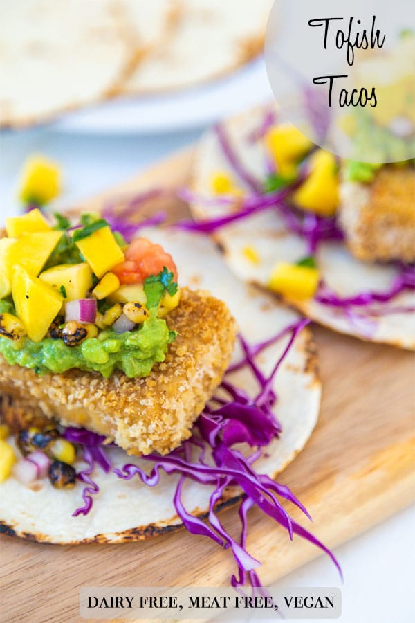 A Pinterest pin for vegan fish tacos with a picture of the tacos on a wooden board.