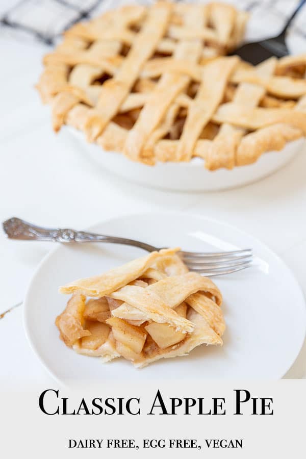 A Pinterest pin for vegan apple pie with a picture of a slice of pie on a white plate and the whole pie with a lattice top in the background.