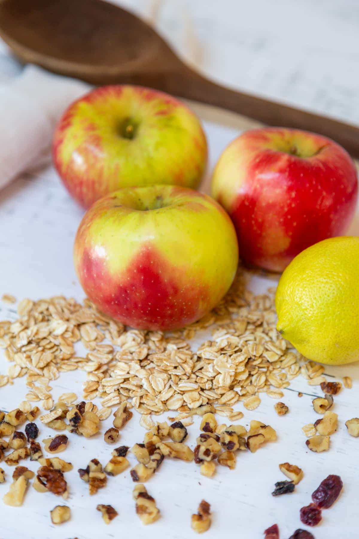 Ingredients for making stuffed apples. 4 whole red apples, oats, nuts, and dried fruit.