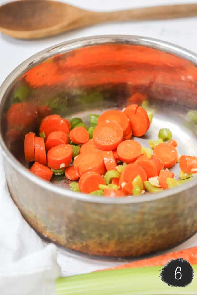 Sautéed carrots, celery, and garlic in a copper pot.  