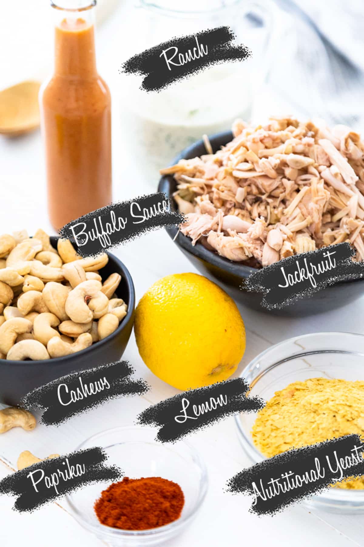 A photo of ingredients for vegan buffalo chicken dip with each ingredient labeled.