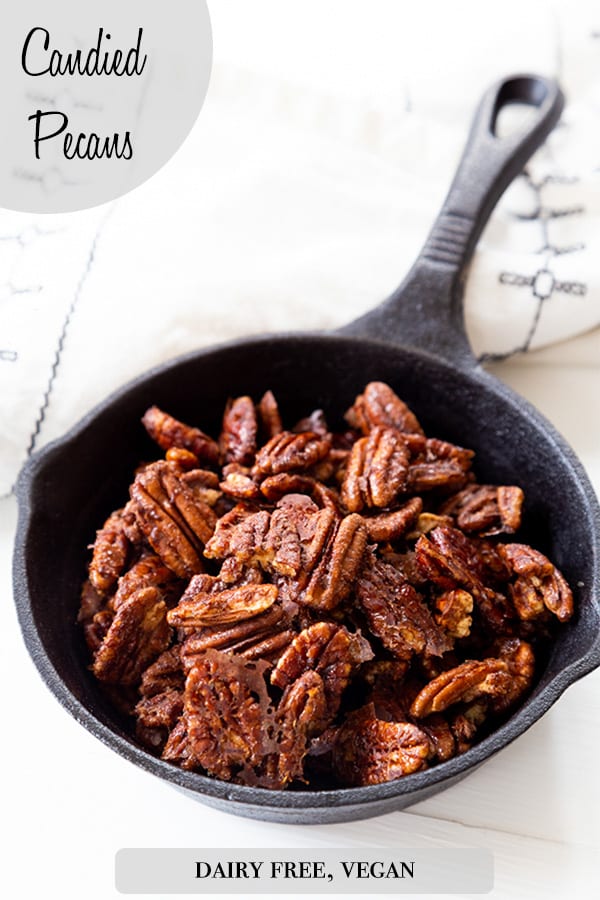 A Pinterest pin for candied cinnamon pecans with a picture of the pecans in an iron skillet.
