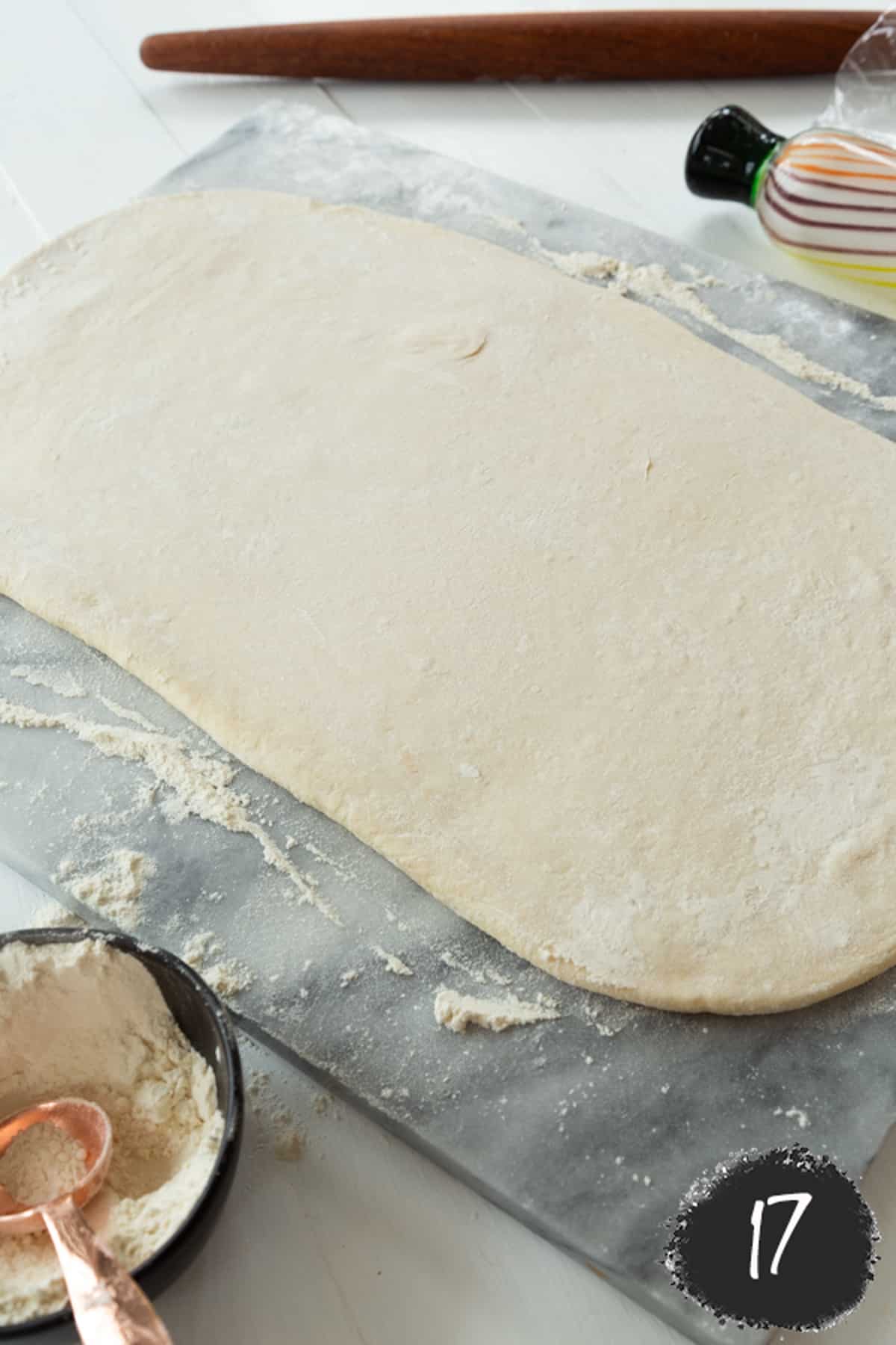 A piece of dough rolled into a long rectangle.