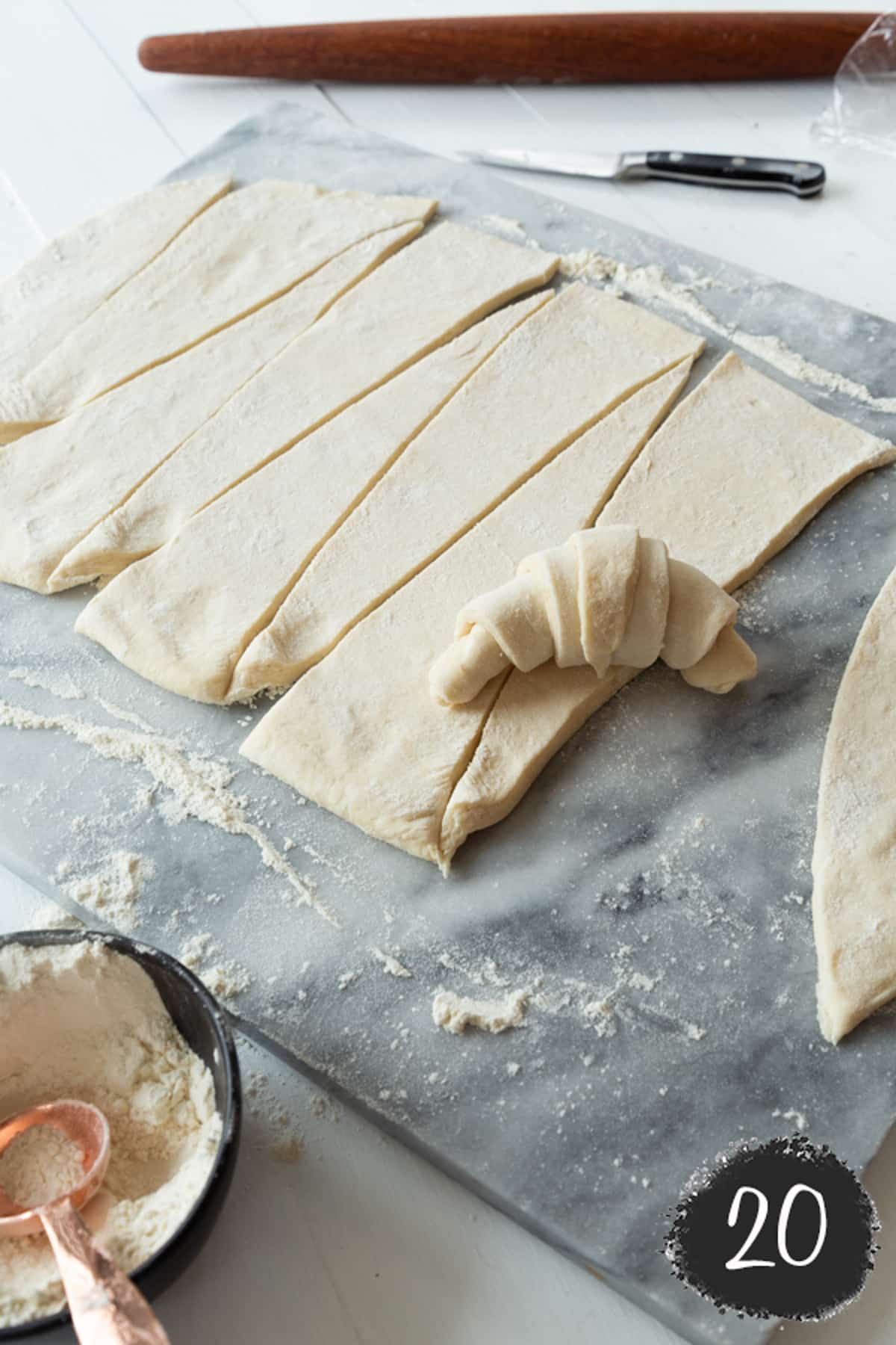 An unbaked croissant and triangles of dough.