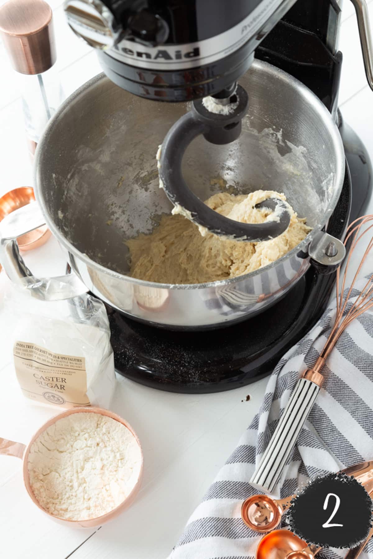 A stand mixer with a dough attachment and croissant dough.