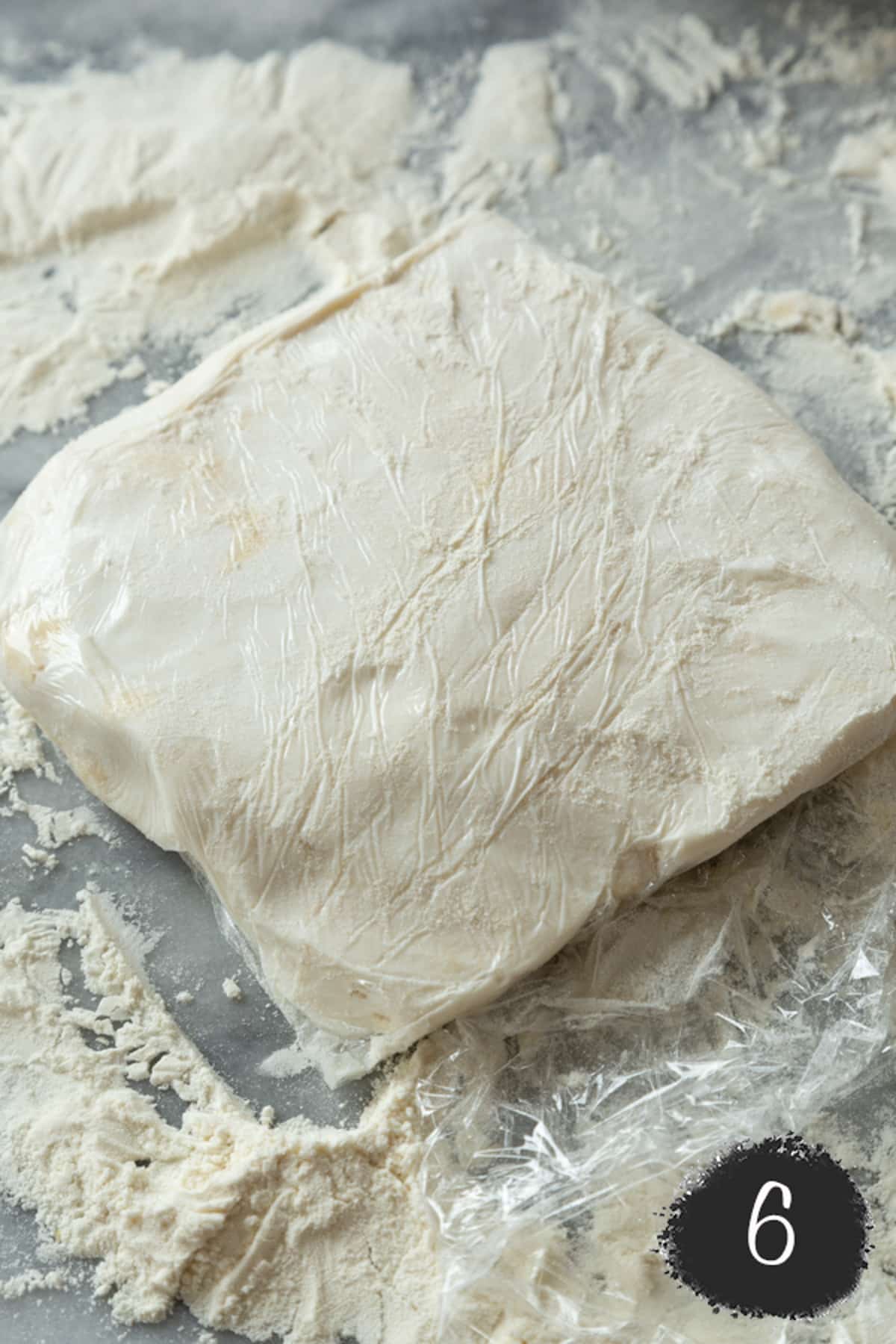 Butter formed into a square with flour around it.