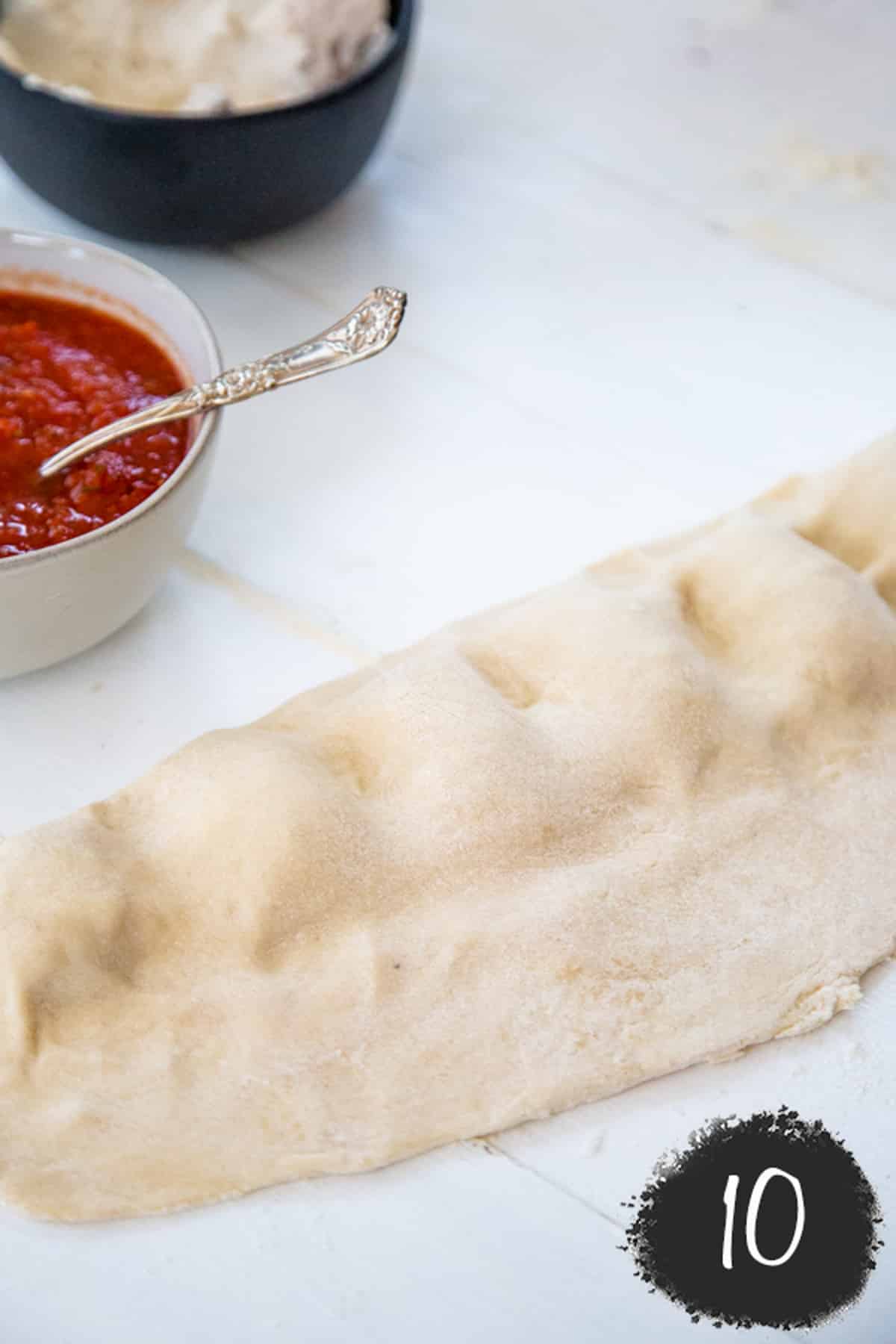 Pizza dough with a filling pressed into individual pizza pockets.