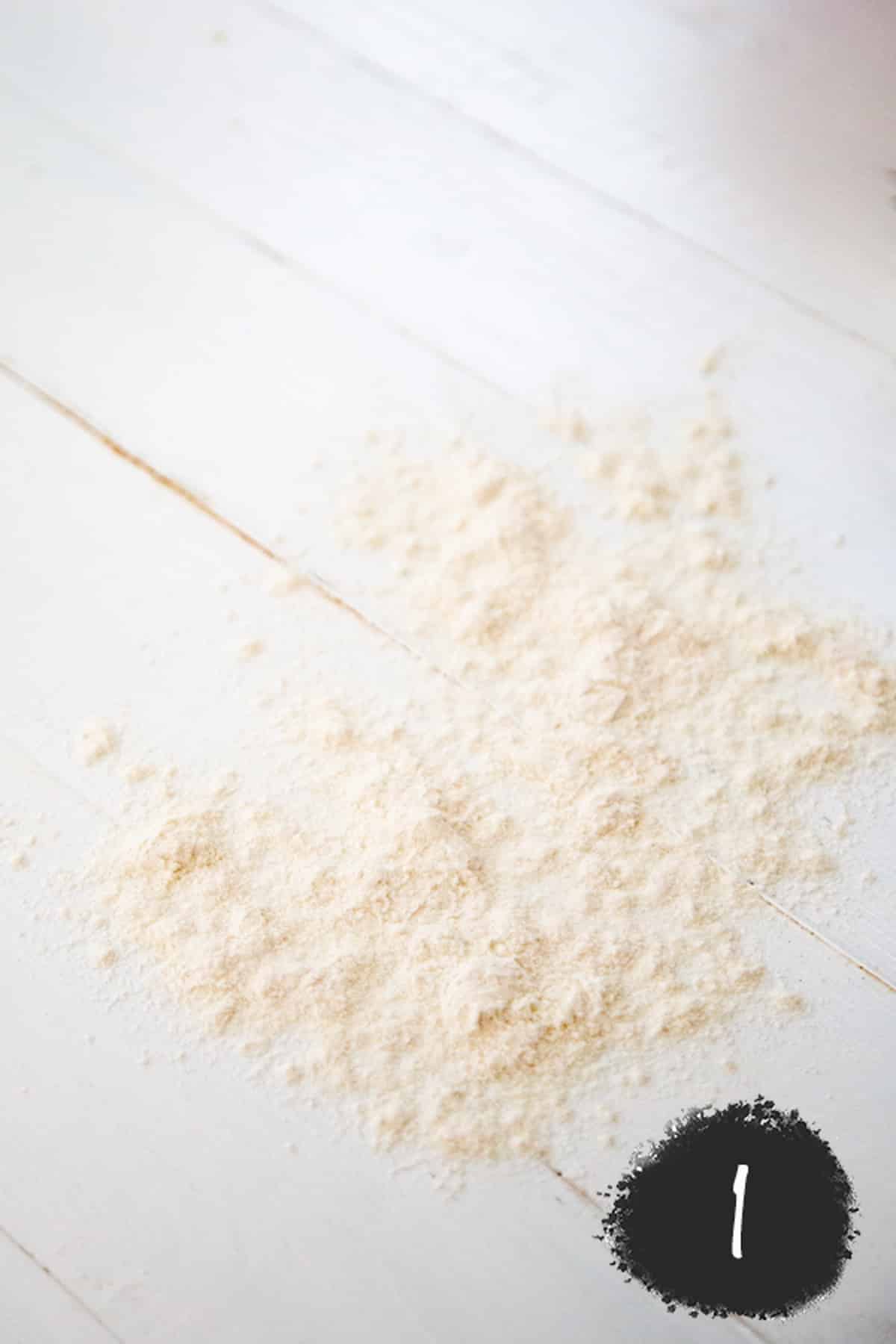 Flour on a white wood board.
