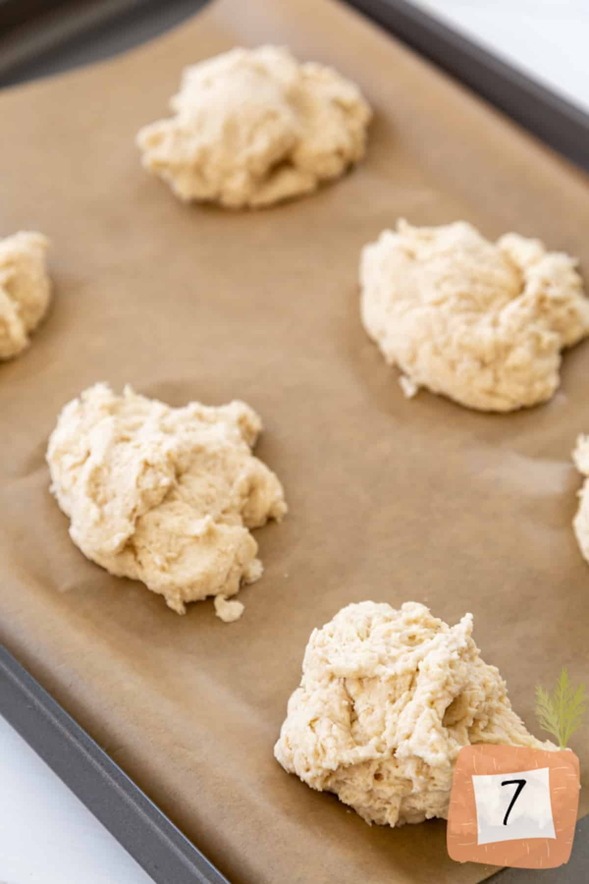 Unbaked biscuit dough on a baking sheet.