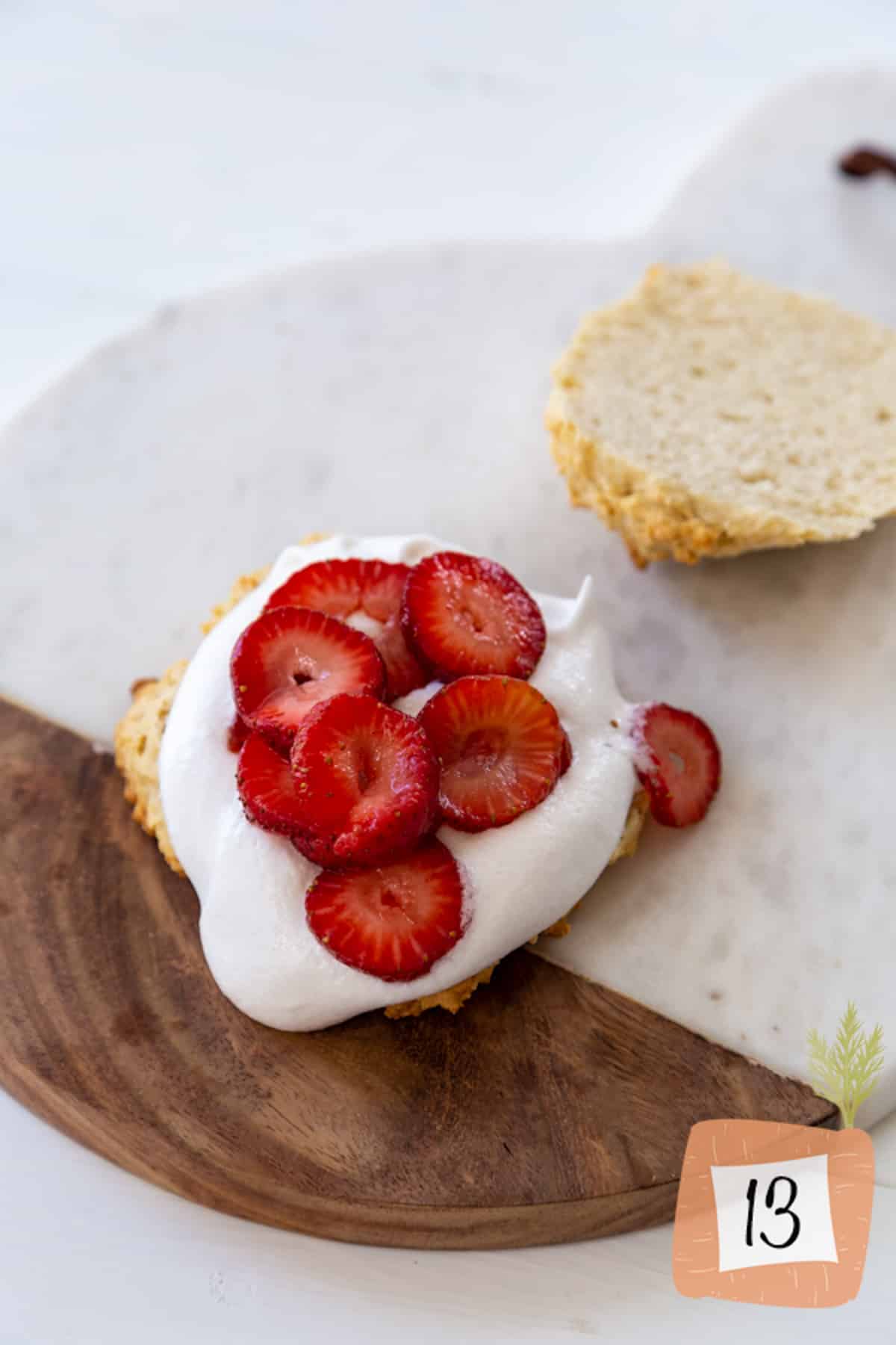 Strawberries and whipped topping on a shortbread biscuit.