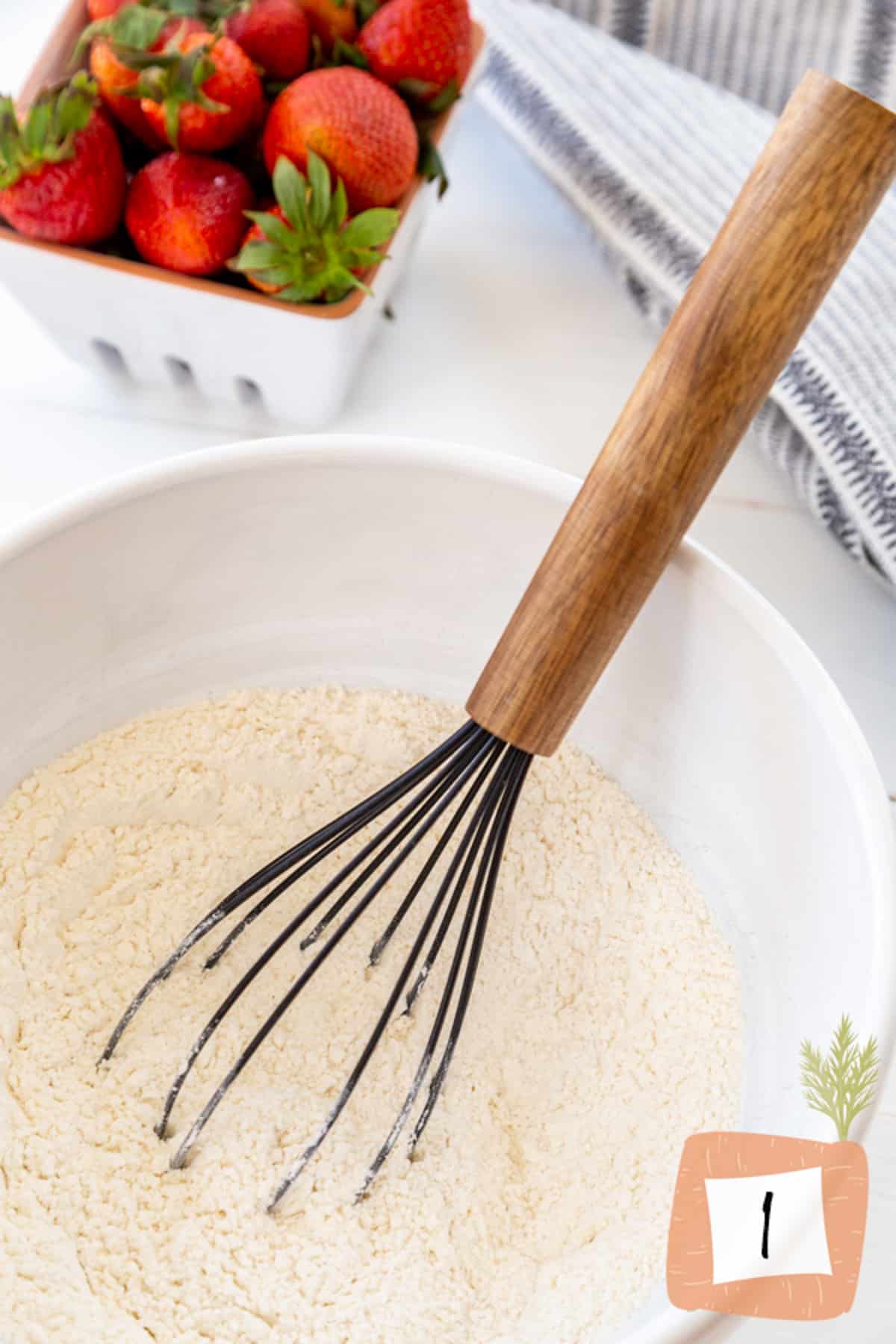 A white bowl with flour being whisked.