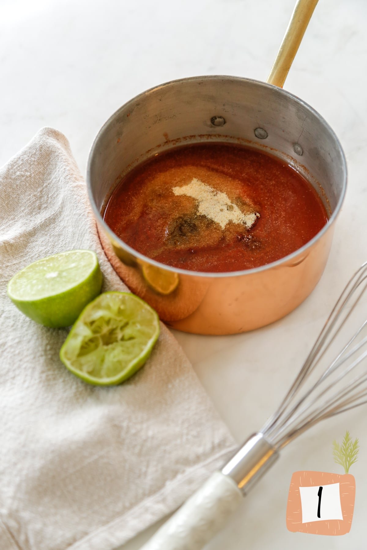 Tomato sauce and spices in a copper pan.