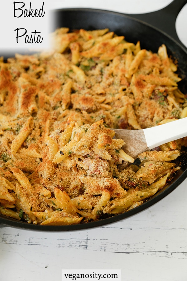 A Pinterest pin for vegan baked pasta with a picture of a skillet of the recipe. 