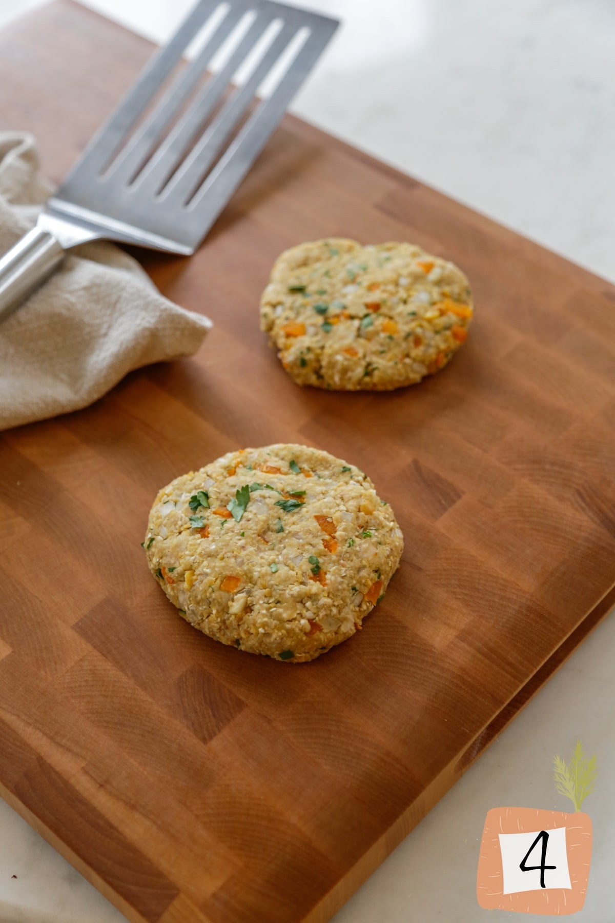 Chickpea burger patties on a wood cutting board.