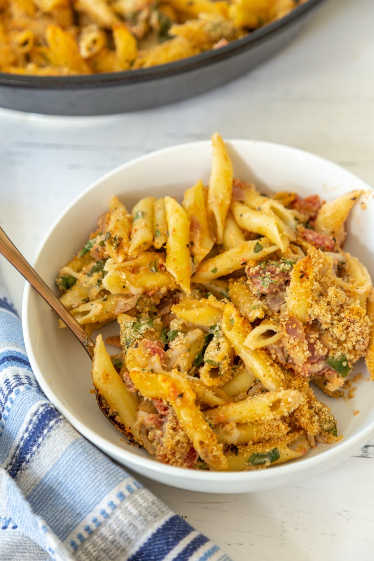 Baked penne in a white bowl.