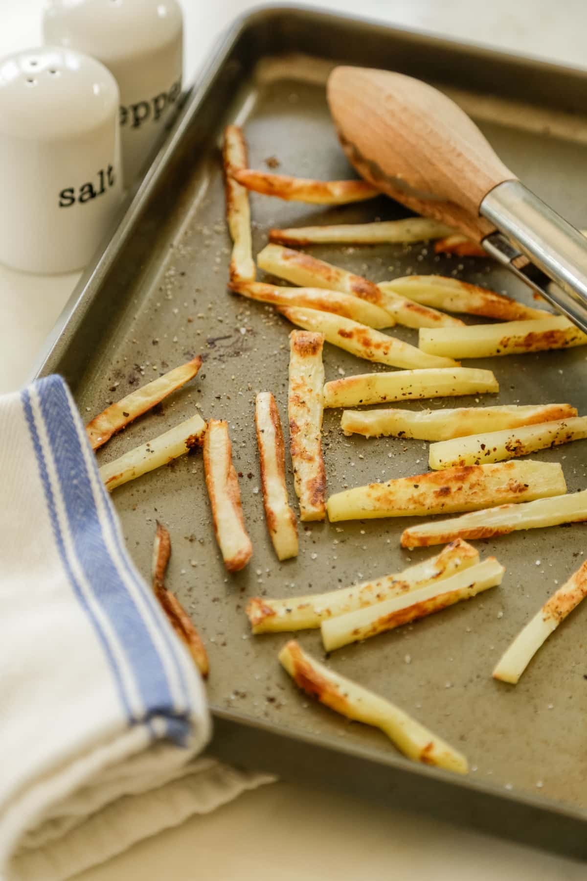 A baking sheet with french fries.