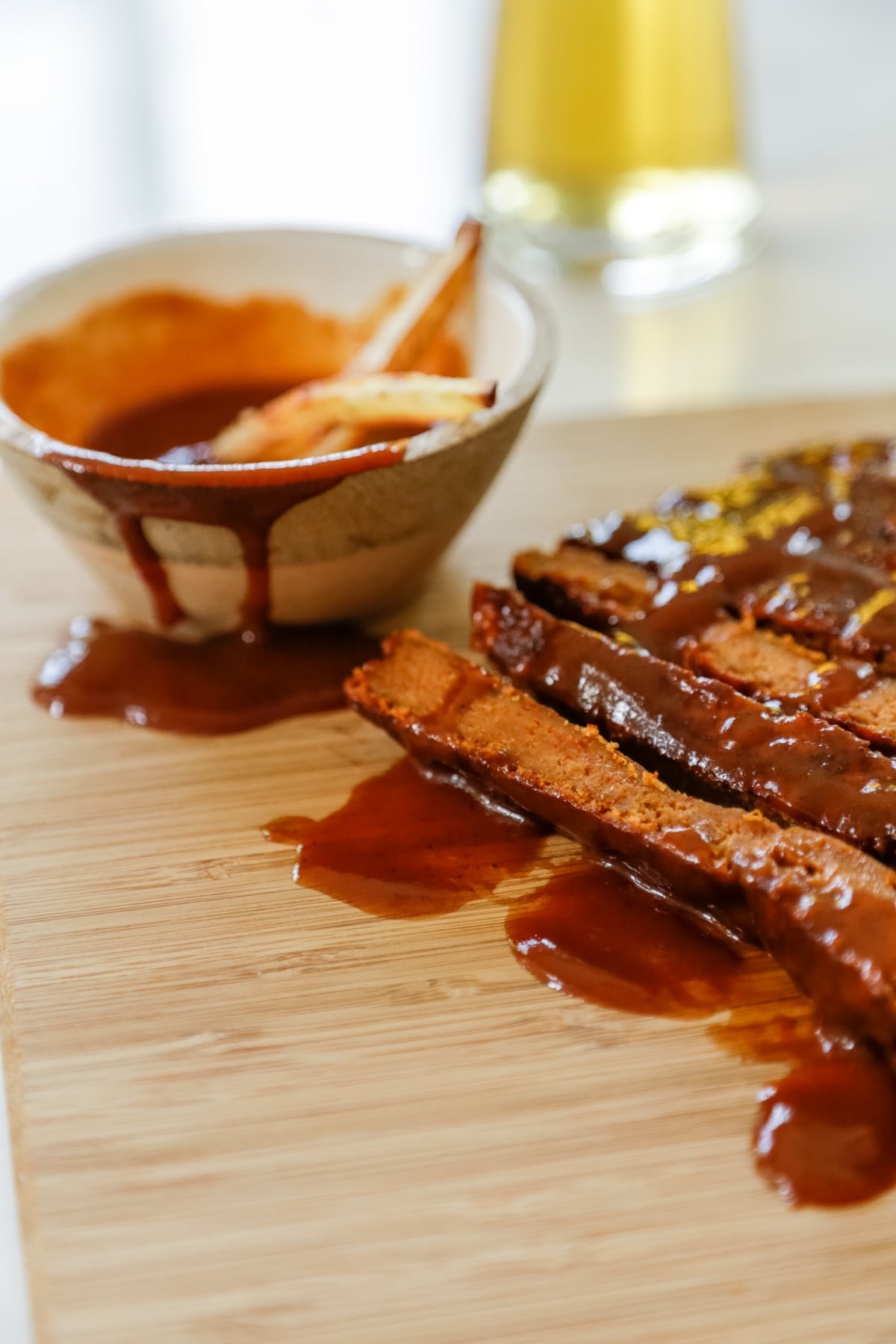 Sliced vegan ribs with bbq sauce.
