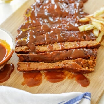 A slab of vegan ribs on a wooden board.