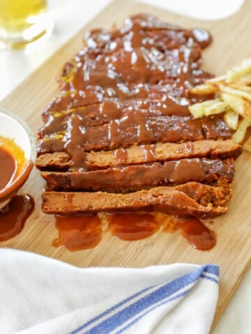 A slab of vegan ribs on a wooden board.